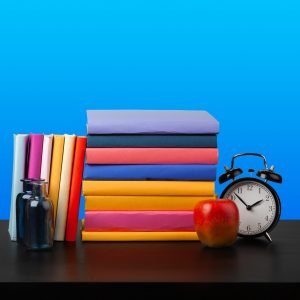 Stack of books on black wooden table, close up